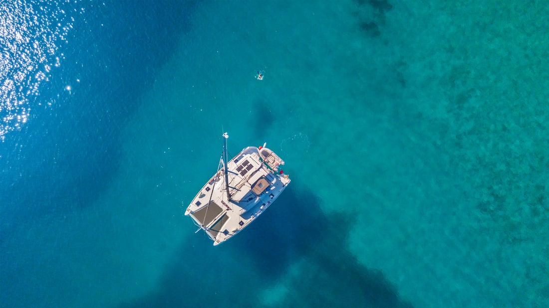 Catamaran Anchoring on Coral Reef